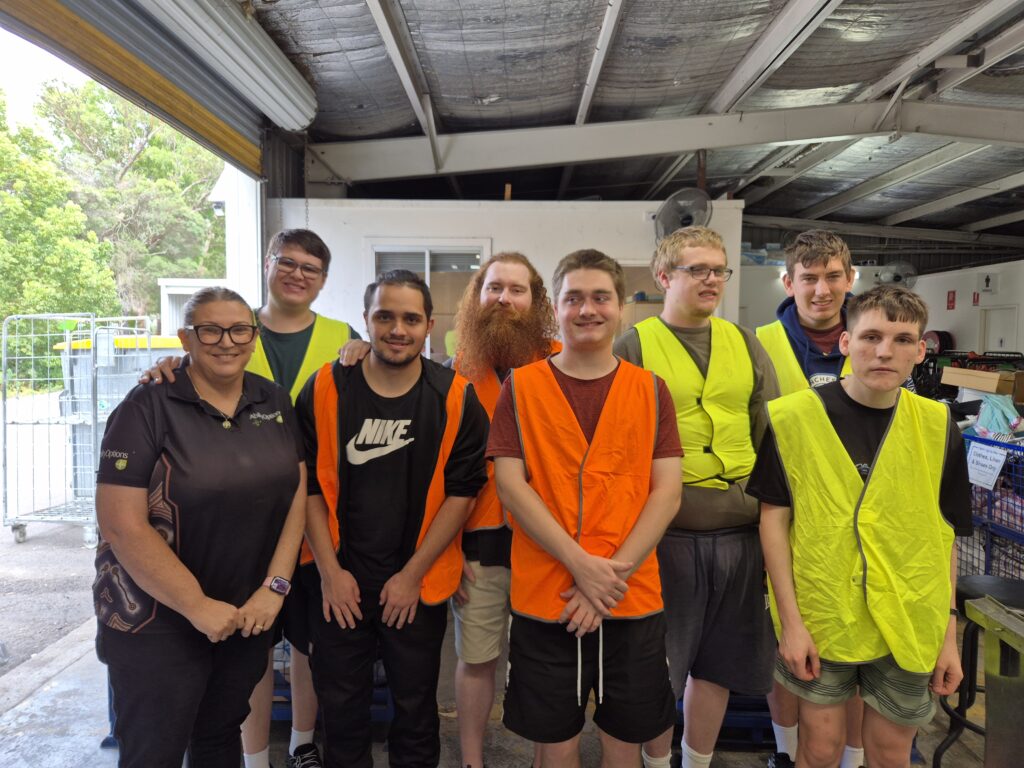 Group wearing safety vests in a warehouse.