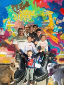 Group with graffiti background and two dogs